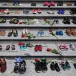 Image of children's shoes placed on the steps of the Vancouver Art Gallery as a memorial to the 215 children whose remains were found at a residential school in Kamloops.